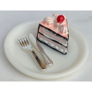 Choc/Berry Cake on a Plate With Cutlery