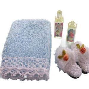 Blue Towel With Lotion And Slippers